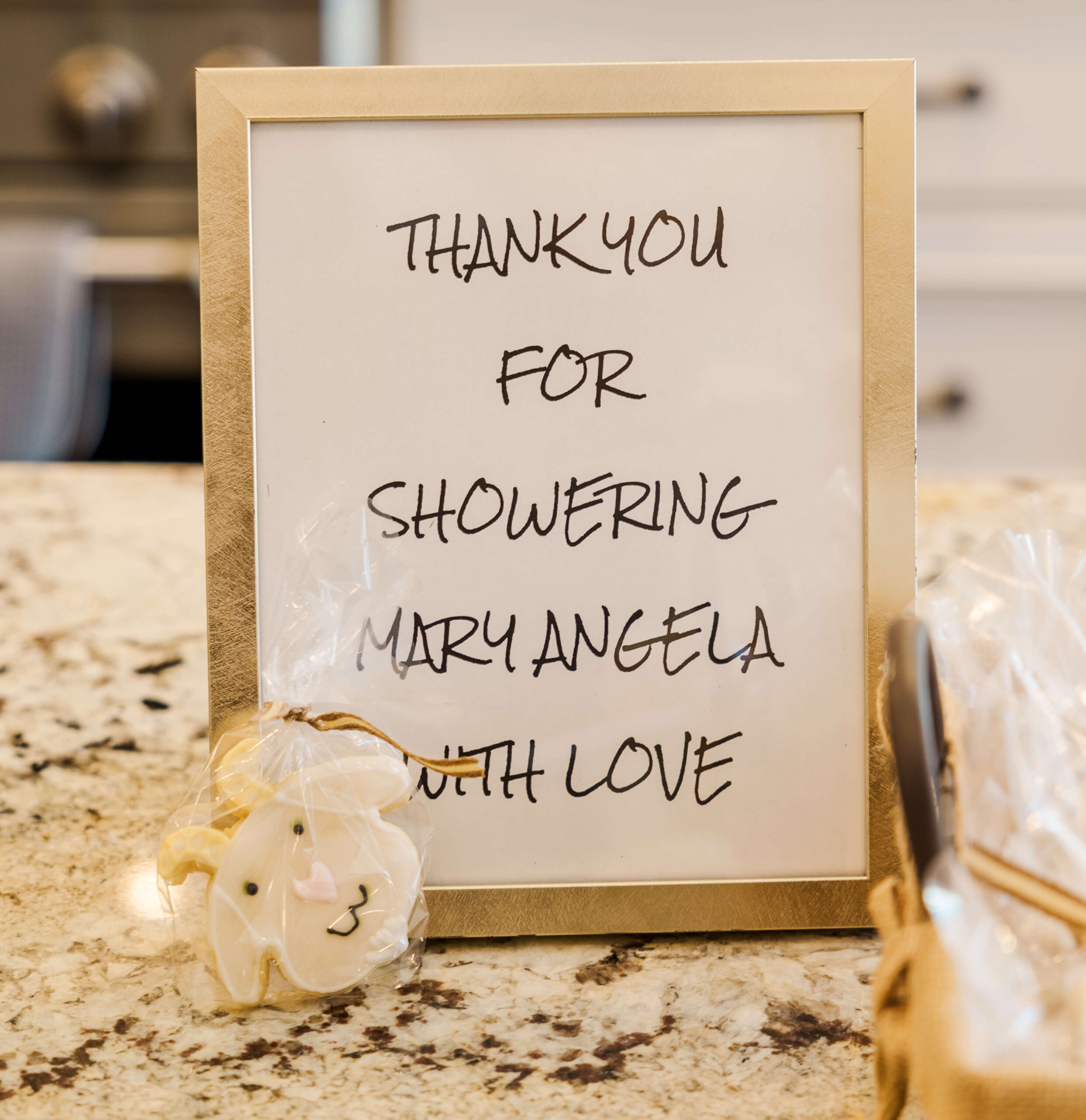 Details of a thank sign from a baby shower with a cookie from one of the bakeries in Fayetteville, NC